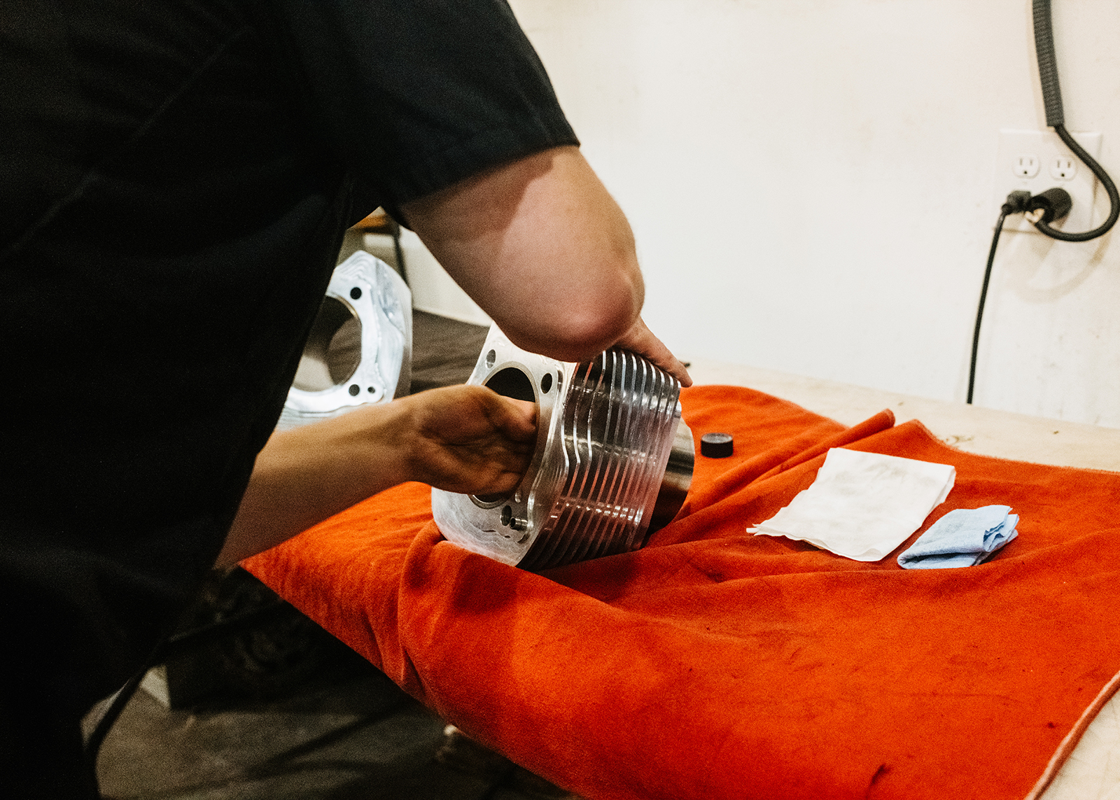 Moonshine Harley-Davidson Owner and General manager Jamie Lima works on a Harley-Davidson V-twin engine cylinder.