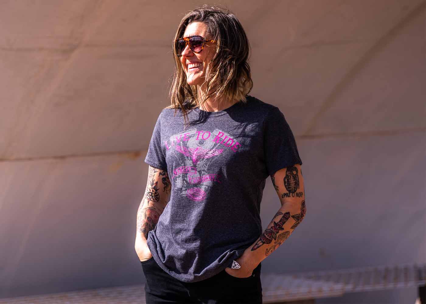 woman with tatoos on arms wearing short sleeve shirt
