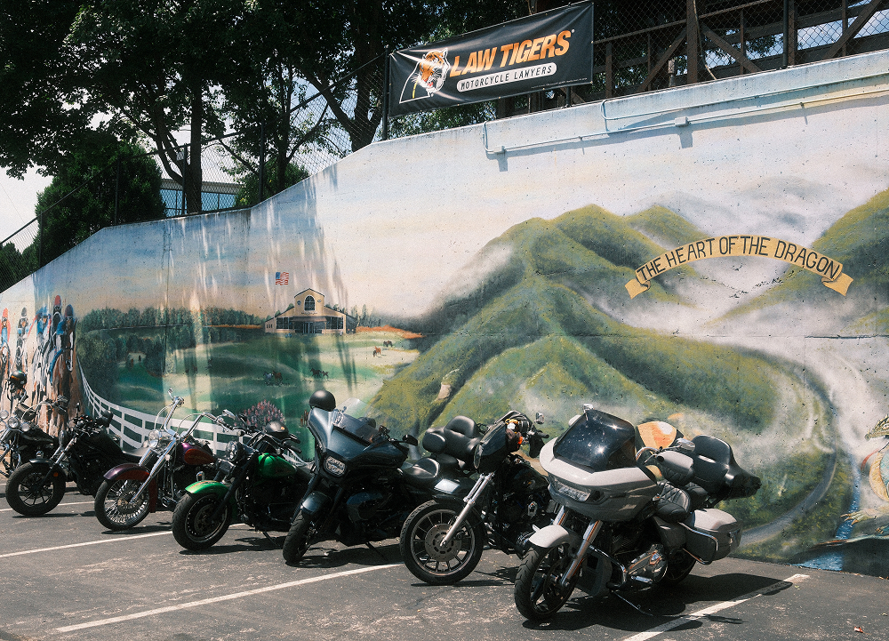 Harley-Davidson motorcycles parked beside a mural celebrating Kentucky’s Heart of the Dragon route