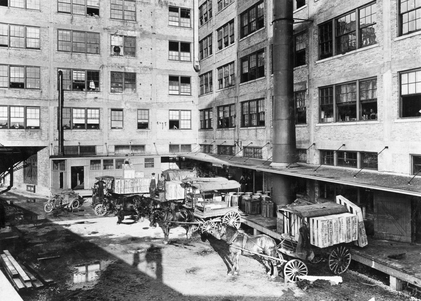 Horses load up carriages of product in loading bays