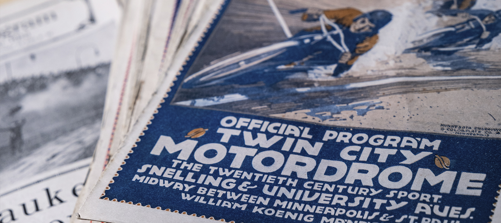Close-up of a vintage Twin City Motordrome program featuring motorcycle racing artwork