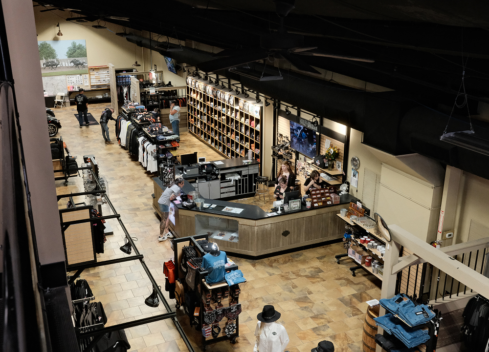 Overhead view of Harley-Davidson apparel and merchandise area with checkout counters and shoppers