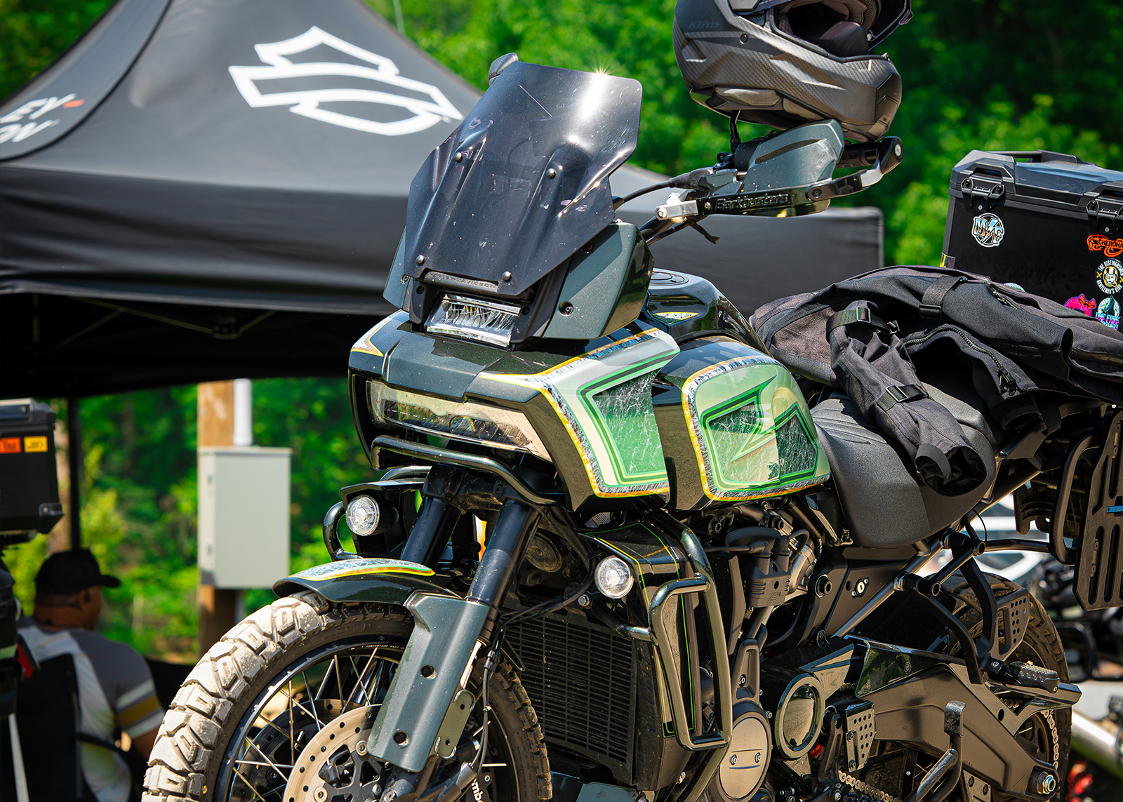 A closeup of a green, yellow, and white painted Pan America in the woods.