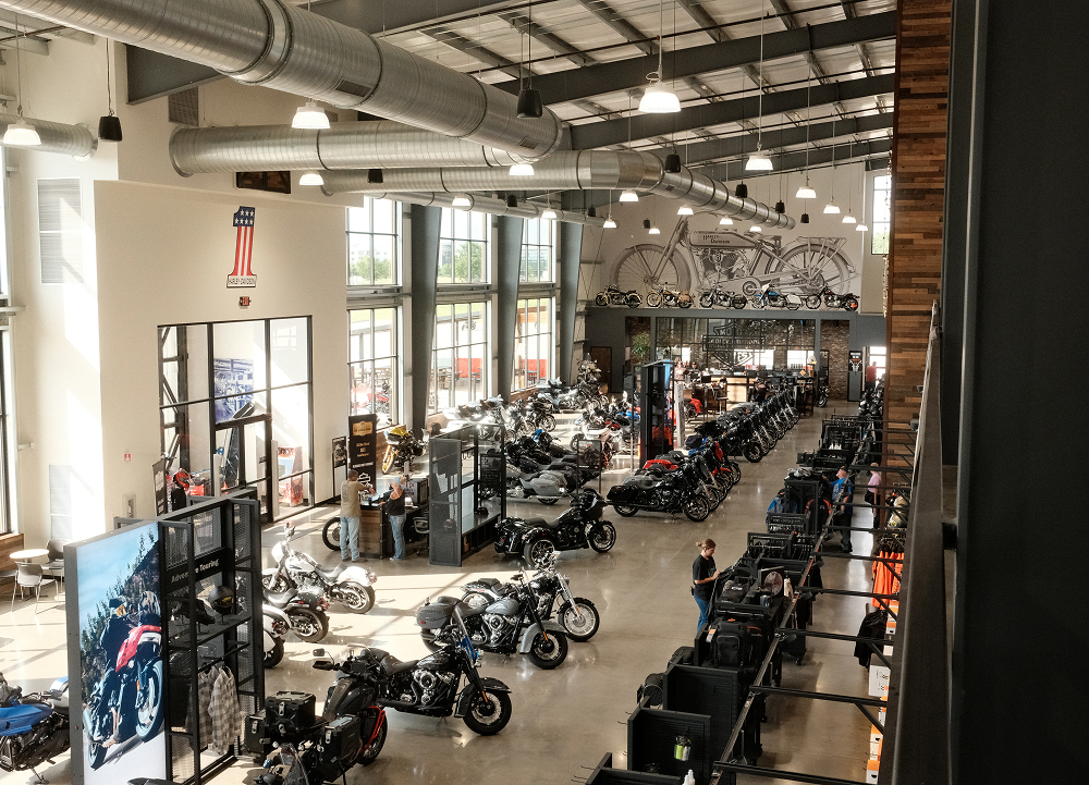 Wide view of Bluegrass Harley-Davidson showroom with rows of motorcycles, displays, and industrial interior design