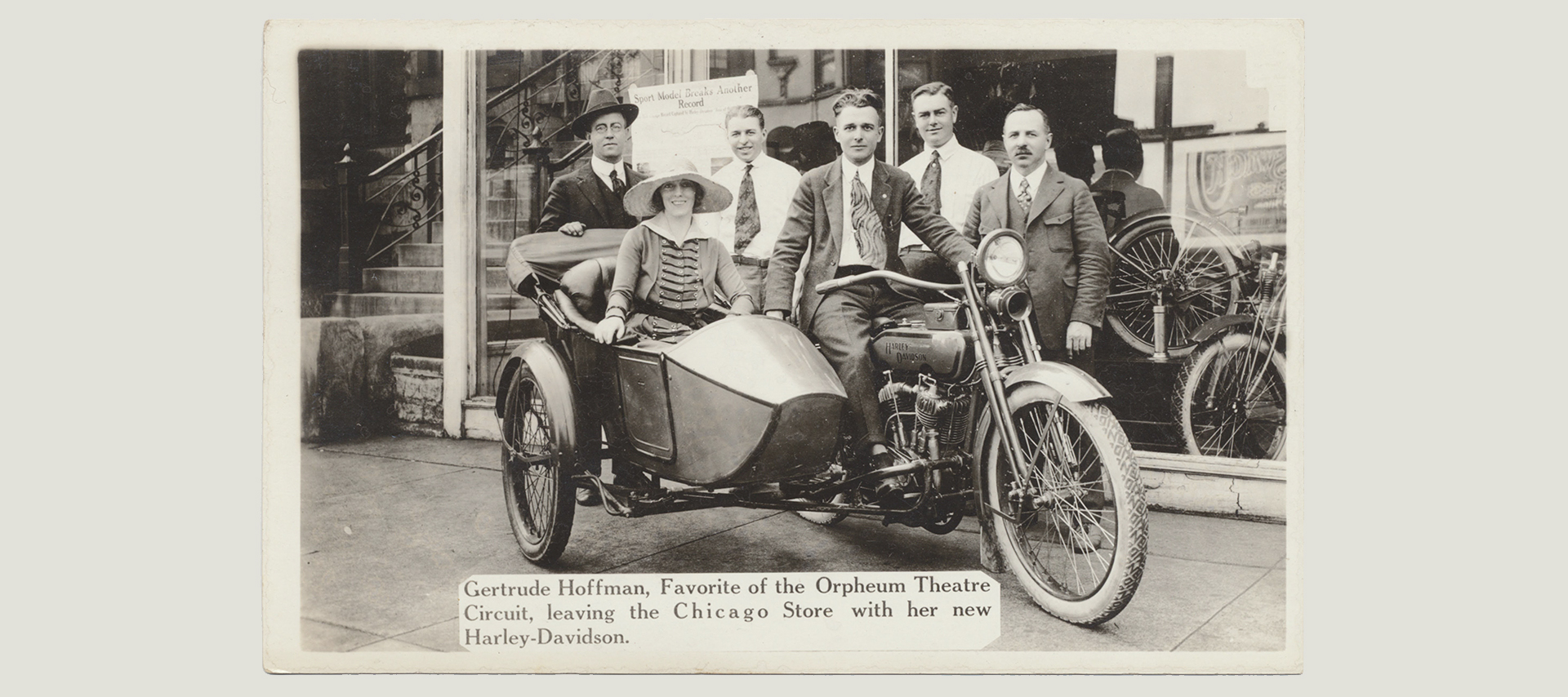 A woman leaving a theater in a side car 