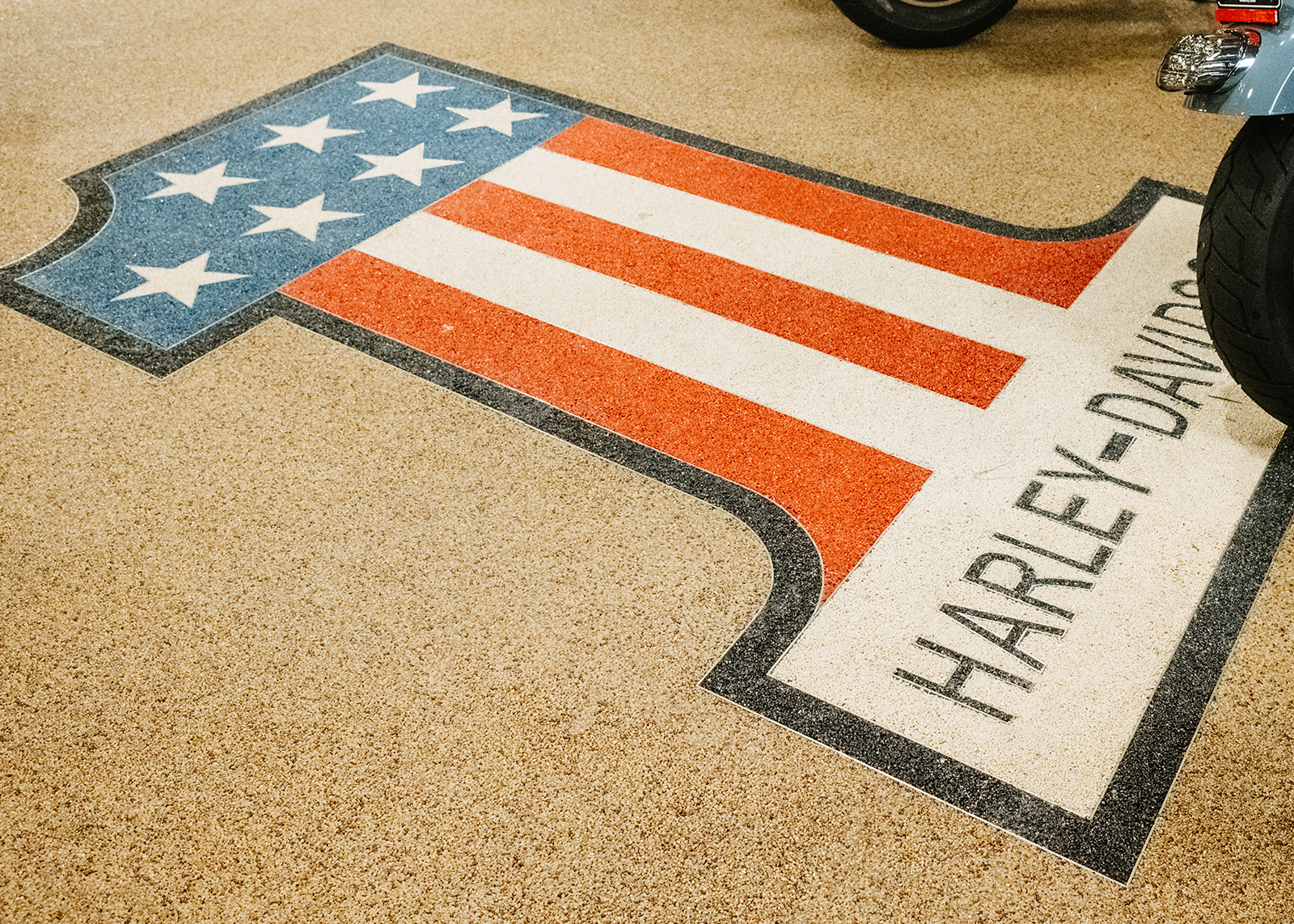 The Harley-Davidson #1 stars-and-stripes logo is inlaid into the floor at White Lightning H-D dealership.