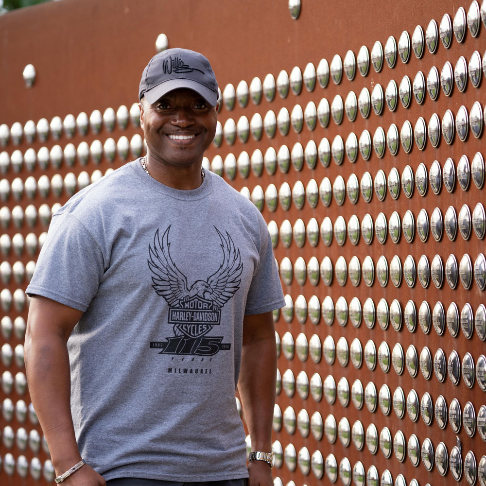 Man in front of rivet wall