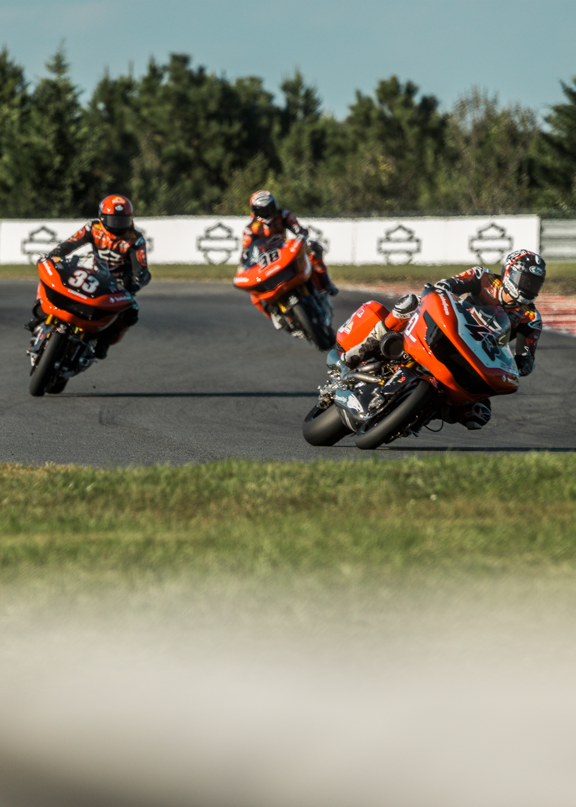 James Rispoli, Kyle Wyman, and Bradley Smith are seen each at different cornering angles as they transition through a chicane during a King of the Baggers race.