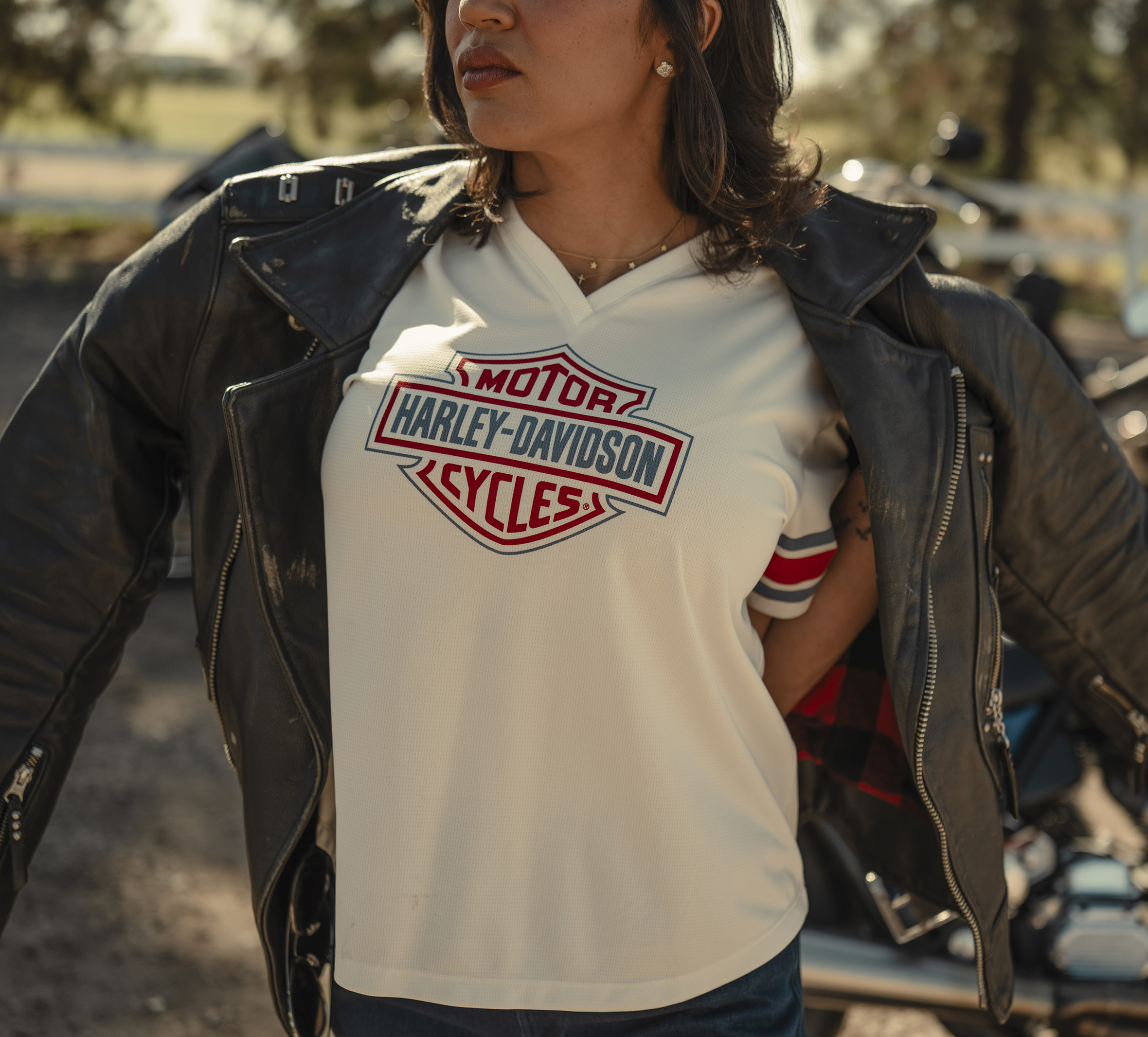 woman wearing H-D Essential Football Jersey under black Harley-Davidson leather jacket