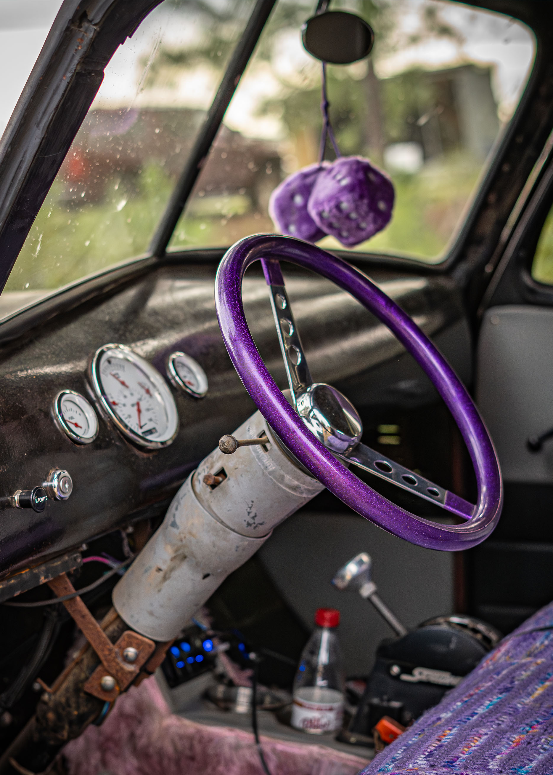 Close up of purple steering wheel and dice