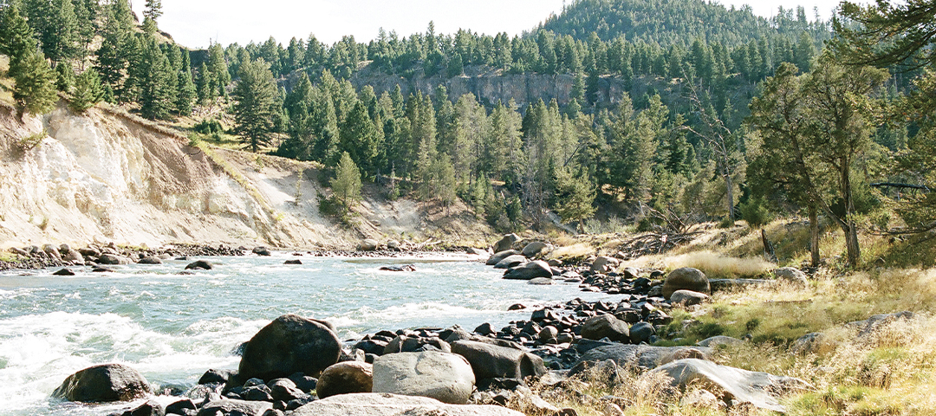 Scenic view of a river at the base of a mountain