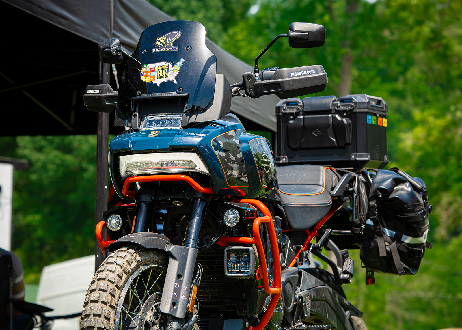 A closeup of a blue and orange Pan America loaded with bags.