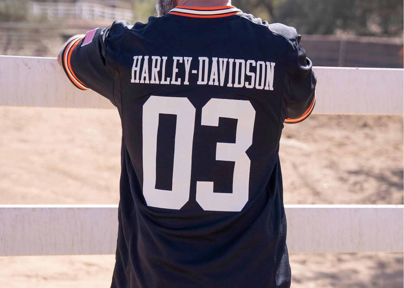 back of a man in shirt that says Harley-Davidson 