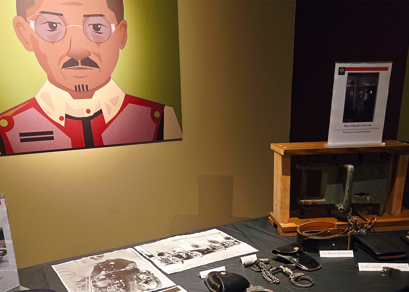 Historic Harley-Davidson exhibit with artifacts and portrait display