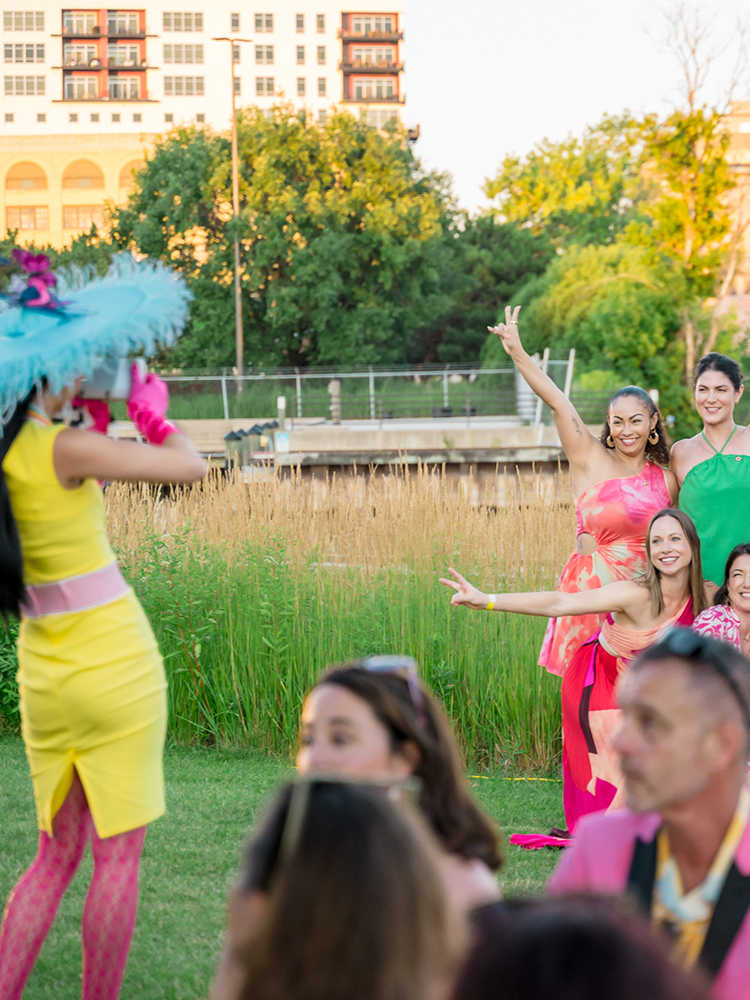 Guests participating in outdoor event activity near waterfront lawn