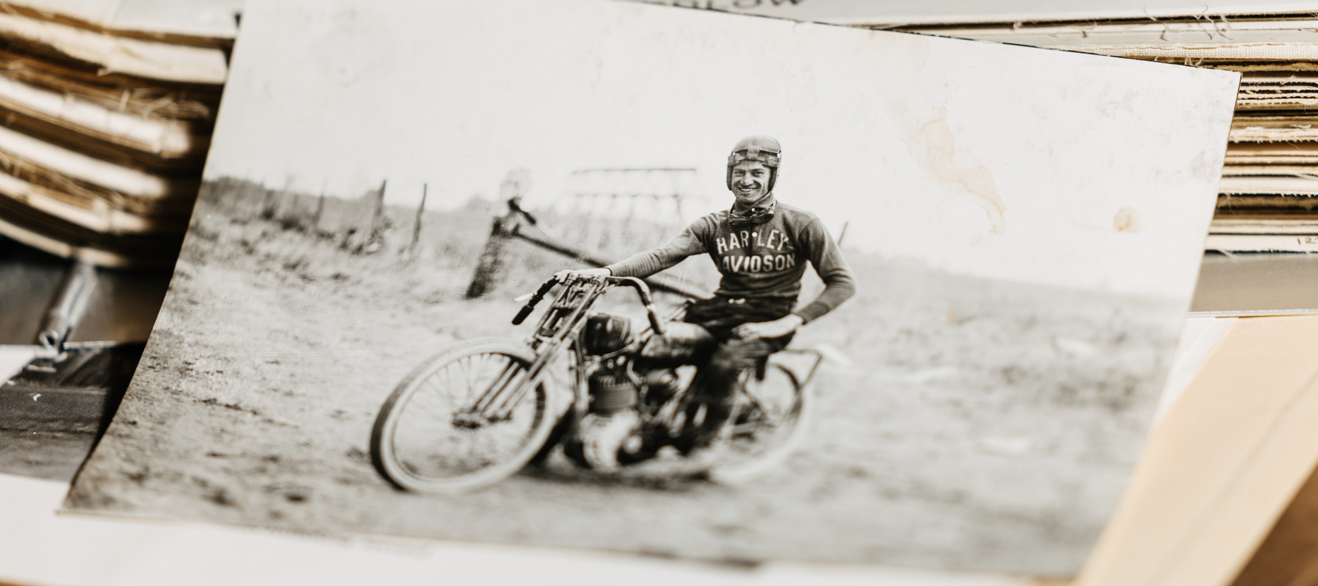 An old photograph shows Leslie “Red” Parkhurst sitting on his Harley in his riding gear.
