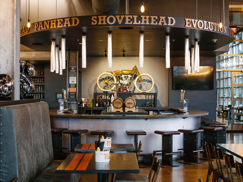 Circular bar area with mounted motorcycle above counter and signage