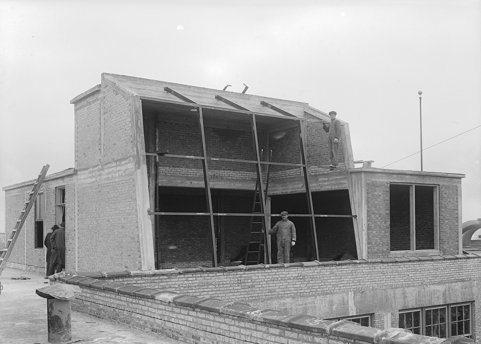 A man poses for a photo inside a building under construction