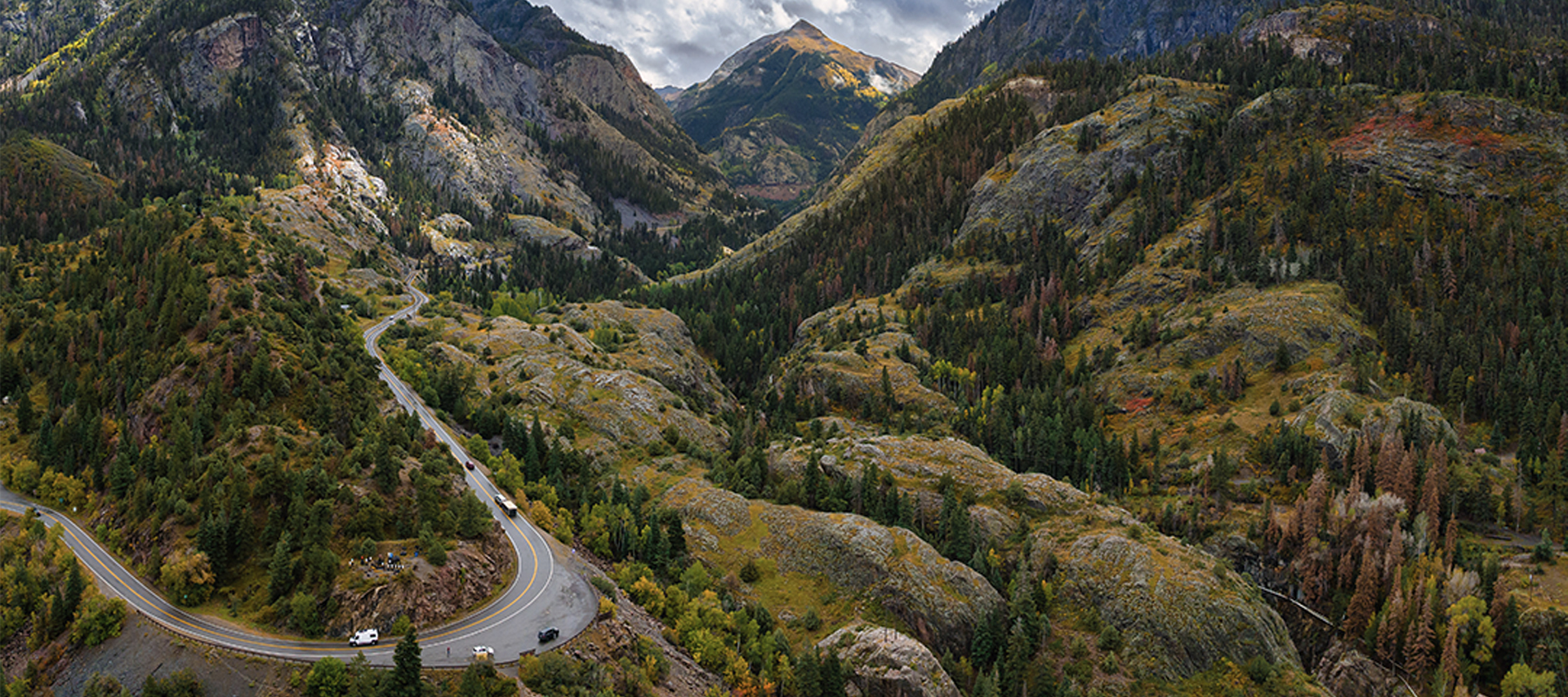A scenic sweeping view of a curving road through the mountains 