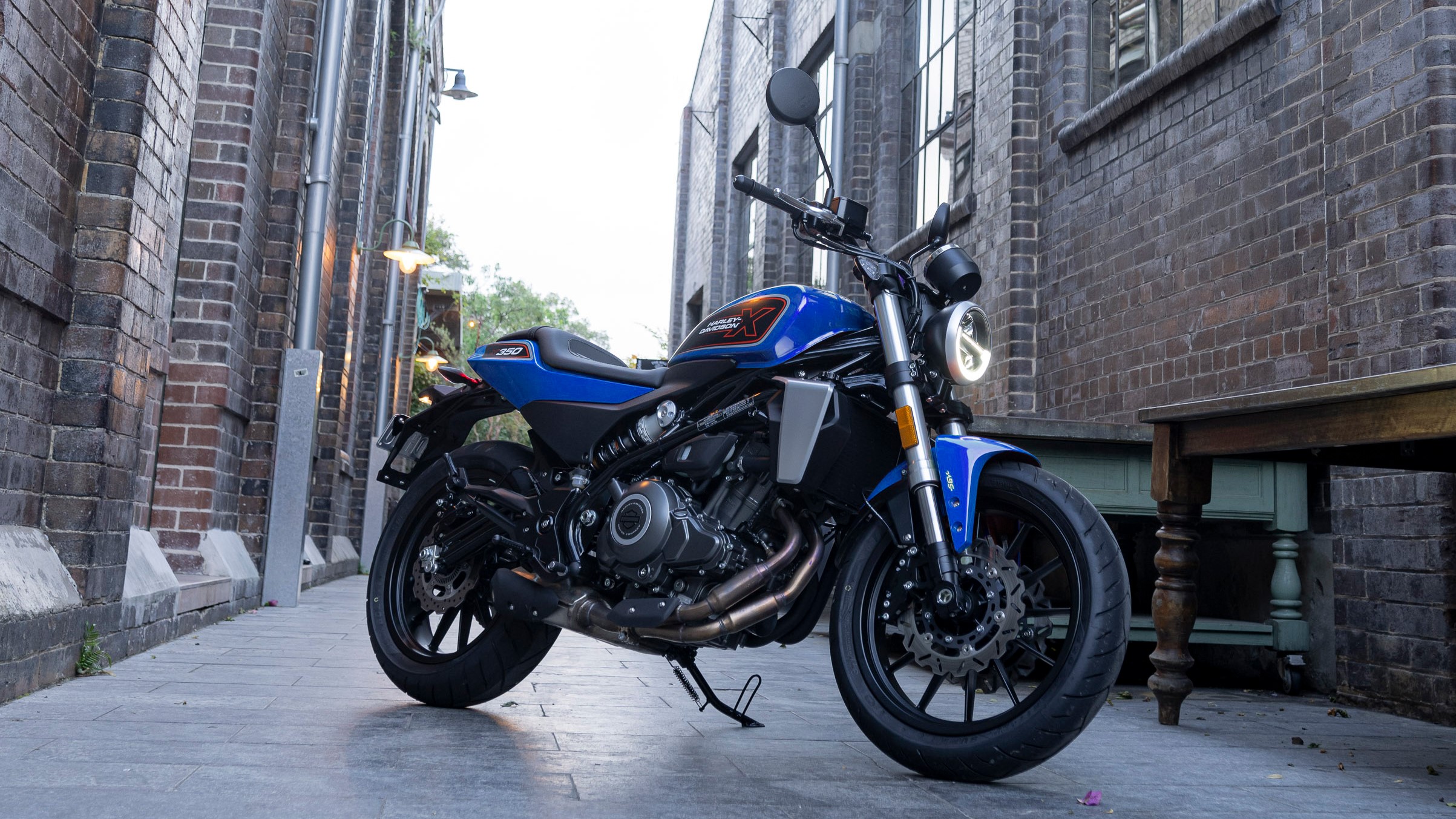 Motorcycle parked in between two buildings 