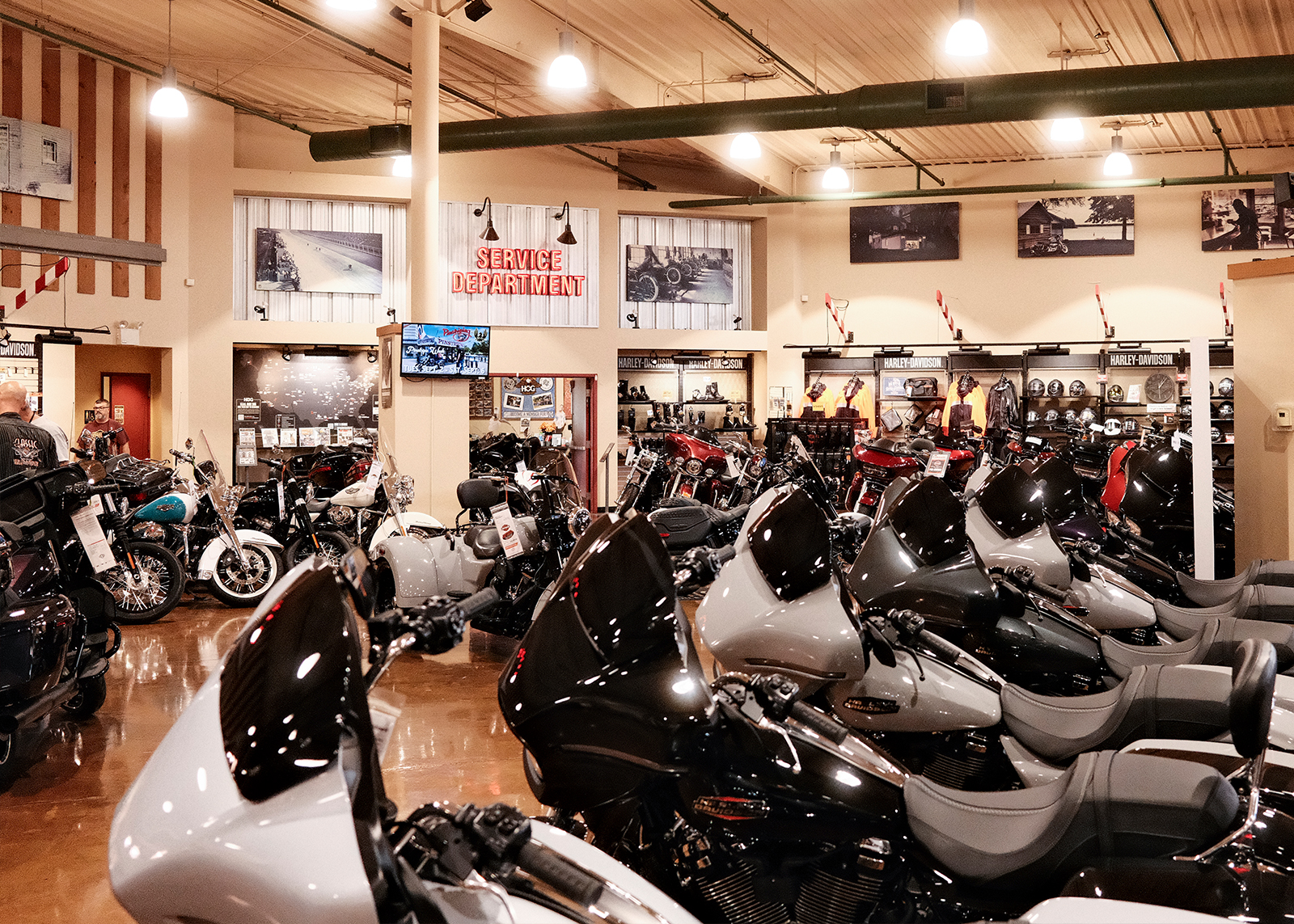 The showroom floor of Classic Harley-Davidson wth motorcycles lined up and the service department in the background.